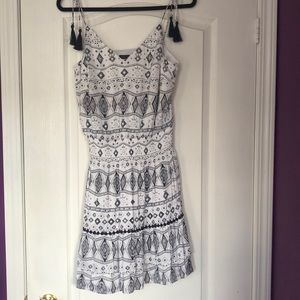 Black and white dress with spaghetti strap with tassels.